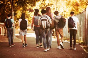 Group of teenagers walking together from school