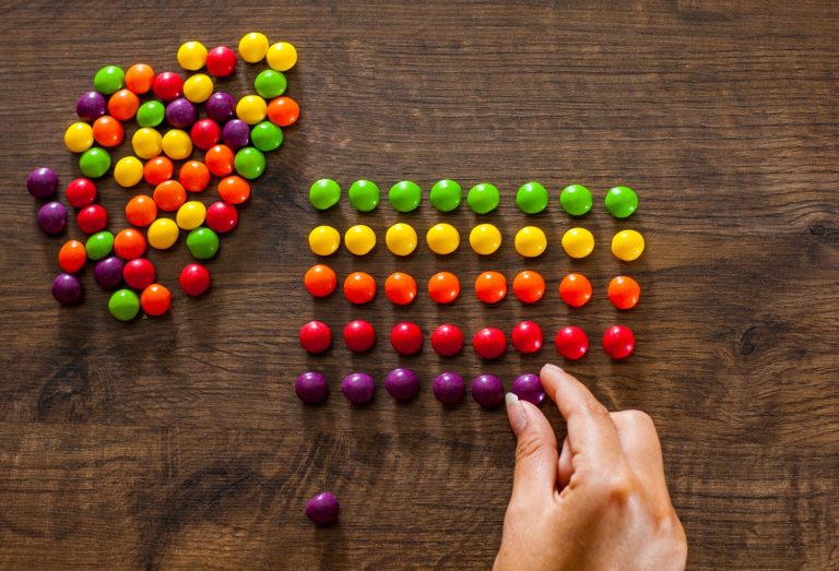 Colored candies arranged in rows per color