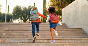 School children on the street running up the stairs