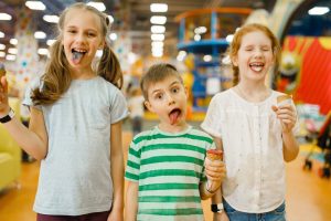 Children eats ice cream in entertainment center
