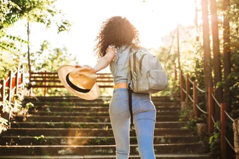 Photo from back of teenage woman 18-20 wearing summer clothes an