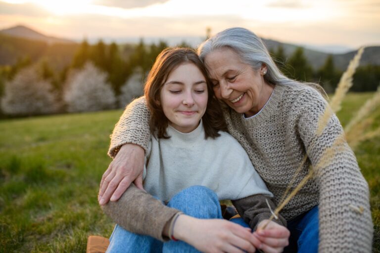 Teenage hugging grandmother mother