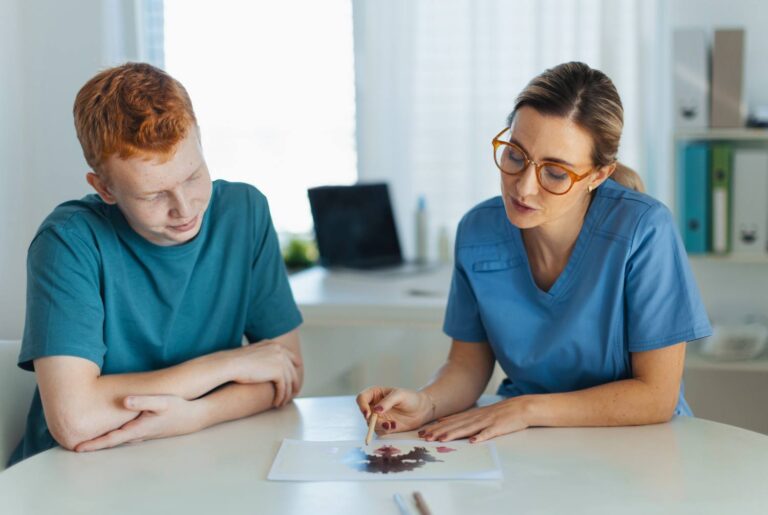Teenager taking Rorschach test during psychological therapy with adolescent psychologist