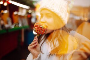 Young woman with caramel apple