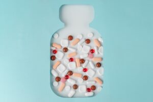 Bottle with different pills. Top view. Concept of drugs, treatment of diseases, medicine and pharmaceuticals.