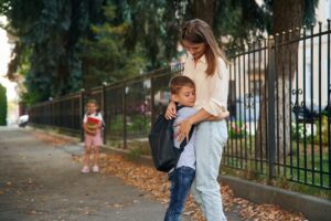 Woman with two kids are going to school, conception of education.