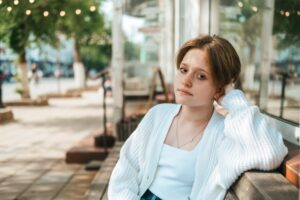 A teenage girl sports edgy short hair and vibrant red hues