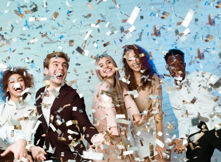 Happy Friends Having Fun Partying Enjoying Falling Confetti Indoor