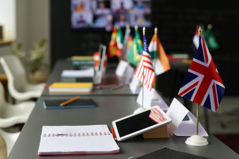 Close-up of table with flags of different countries on it in the classroom at school SSUCv3H4sIAAAAAAAACpxSy27jMAy8L7D/EOi8BuS33V9Z7IGS6FiobBmS3KII8u+VH0oY9LY3c4Yajsm5/f51uTABXkv2drltVay1MasPDoK2c4T5nxN3OCt0FPlwZcMpAJpWqHSwToOhoIAgxxkmjOC8GrPB951kPkBYPXriZXCIi36PSJ4E/LiGgM4HK19w5RAmH/Su/ERxsV6HZbTBekosdlY1BcDA9LUBxJGEgNf4Cy+e0r7+HvUlETsZX0SKsVP1cLyKHUvQIf5fL4+Pfw/PV5zlZvp2J64dGoRjj6dH1nBeyULIbBBQZBW0RSZkC1lRQKug76qirdJkJpWoSylVlndbs8I669oKMuRNiTUoqITYLR0+2PtnvMe0r+h0AKvSlqzsw0owW0NJbIJewMHLu8VpqecrQWwY98wlJWnXObgvuilmrF1AmO3uQxyDCR/B+9iuEk4PGxNuJzJntmFf2KnKVLz8VuZlWZU177q8r3rO67xjNKyjjjq7nWRwXYwFhdvQx3VpjJu+51GyrR53/pHooyUOfba8hvtsqInGj5yfPU3KN438ybXtk3uk/+T6/qBornaDWtGD6e0/GaDohSwgq3mvYrqUzLpBiKwAUcpBls3AMQbm/g0AAP//AwAXNtzPcAQAAA==