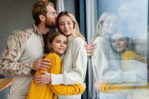 Beautiful happy young family hugging and kissing indoors