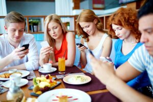 Group of teenagers using mobile phone - Social Media in Recovery - Is It Time to Ditch All Social Med