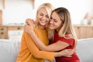mother and teenage daughter hugging each other