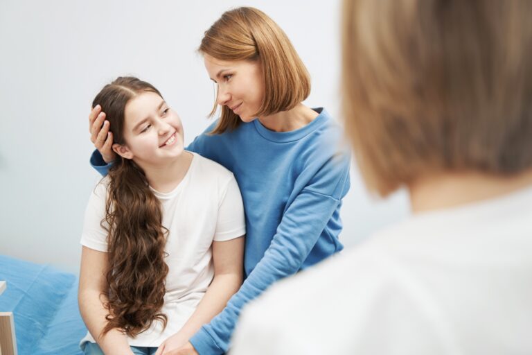 mother and daughter smiling at each other during a counseling session